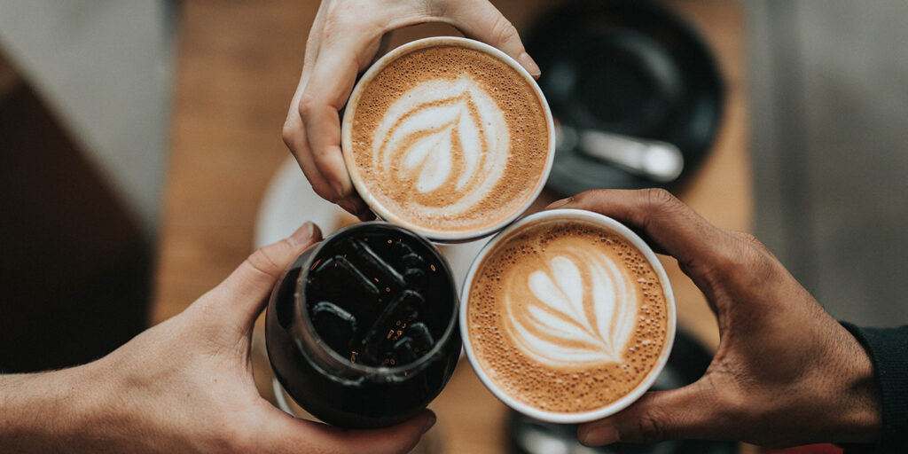 people holding cups of Coffee